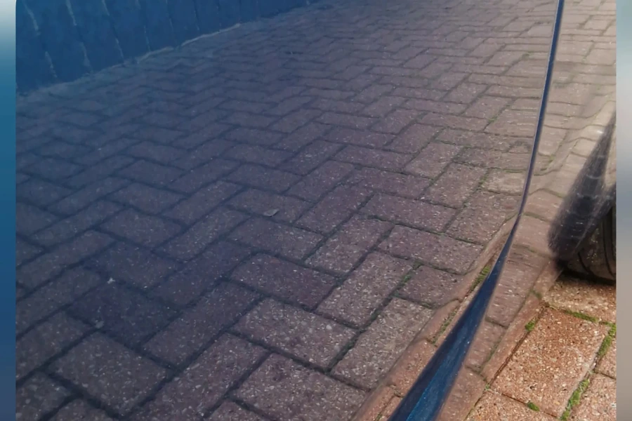 Car bodywork after scratch removal treatment showing smooth restored surface